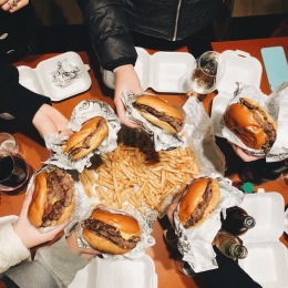 people holding burgers