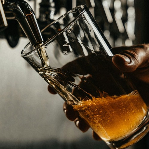 a person pouring a drink