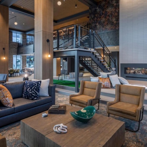 a clubroom with couches, tables and chairs