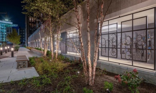 a building with trees and plants in front of it